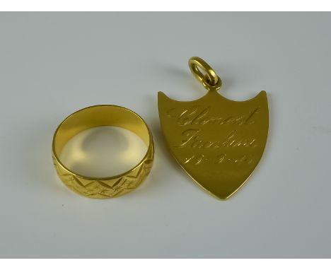 A 18ct Gold Wedding Band, Modern, size K,  and an 18ct gold shield pendant 32mm x 23mm, inscribed to the front "RHGR" and to 