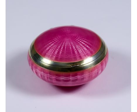 An Early 20th Century Silver Gilt and Pink Enamel Circular Compact, with import mark for T K & Co. London 1925, slightly dome