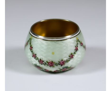 An Early 20th Century Silver, Silver Gilt and White Enamel Circular Salt, hallmarks rubbed, the exterior decorated with rose 