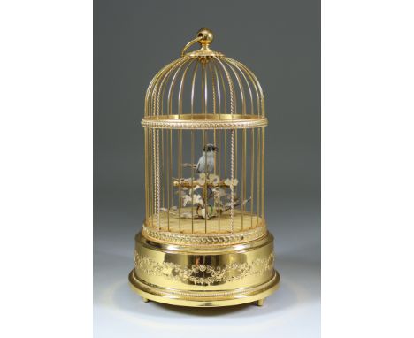 A Swiss Reuge Musical Bird in a Gilded Cage Automaton, No. 5272, 11ins high, with turned hardwood base and cylindrical glass 