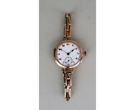 A Lady's Manual Wind Wristwatch, 9ct Gold case, 31ins diameter, the white dial with black Arabic numerals with a red "12", su