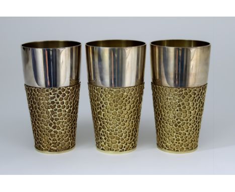 Three Elizabeth II Silver and Silver Gilt Beakers, by Stuart Devlin, London 1970, each of plain polished and tapering cylindr