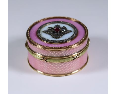 A Modern Two Colour Gold Metal Enamel Ruby and Diamond Set Circular Box, the lid set with oval cabochon ruby and old cut diam