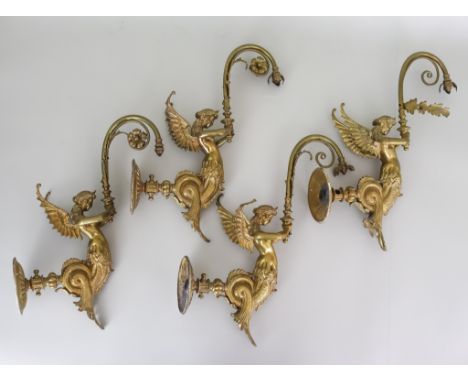 Four Cast Brass Wall Lights, Early 20th Century, modelled as fabled creatures, half-mermaid, half-angel, holding curved lamp 