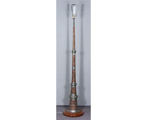A Near Eastern Embossed Copper and Silvered Electric Standing Lamp, on circular wooden base, 13ins diameter x 73ins high