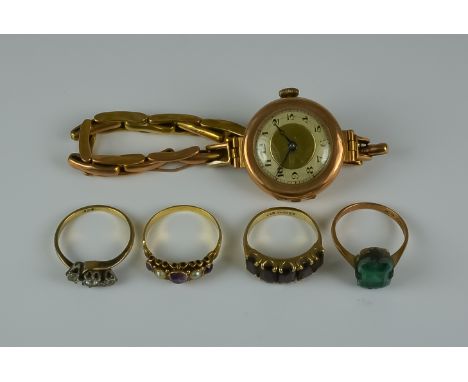 A Mixed Lot of 9ct Gold, comprising - four gem set rings, sizes M,O,L,L, and a unnamed 9ct gold cased manual wind lady's wris