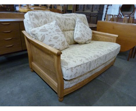 An Ercol Blonde ash settee 