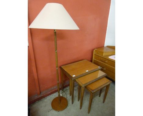 A teak nest of tables and a standard lamp 