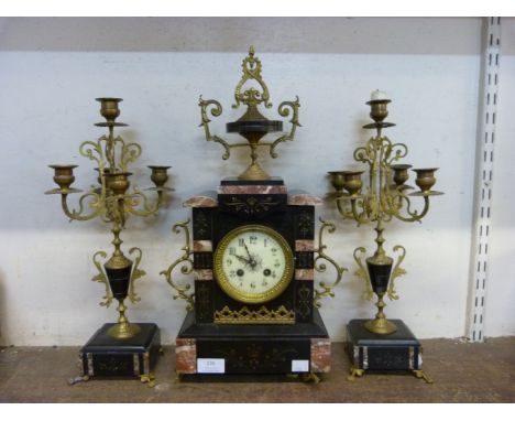 A 19th Century French Belge noir clock garniture, the movement signed Japy Freres 