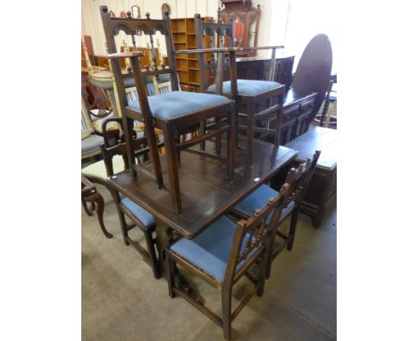 An Ercol dark elm eight piece dining suite 