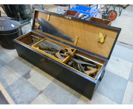 A vintage painted wooden tool box containing woodworking tools 
