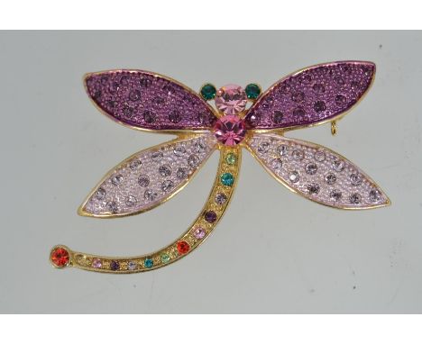 A good vintage yellow metal dragonfly brooch with green bezel set eyes and pave set wings and body with roller clip clasp. We