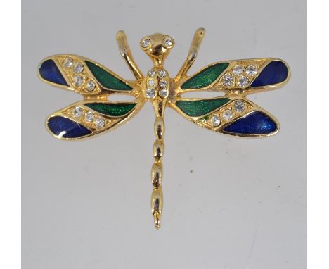 A vintage brooch in the form of a dragon fly with enamel and paste set wings and eyes with roller clasp. Measures 3.5cms.