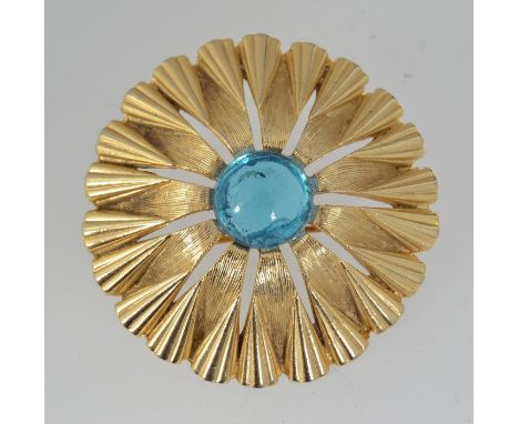 A 1950s Sphinx gold tone brooch pin with central blue green turquoise glass cabochon with roller clip clasp Signed Sphinx. Me