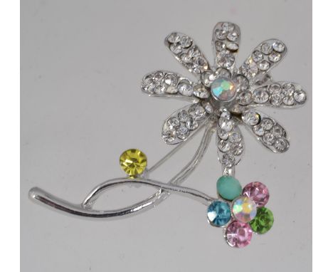 A vintage white metal flower brooch with paste set petals and roller clip clasp. Measures 6cms.