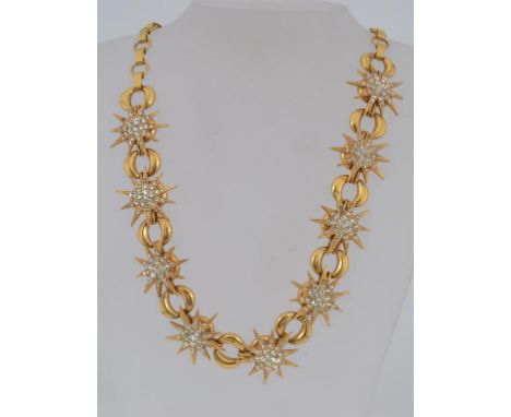 A vintage yellow metal statement necklace with paste set stars and oval links with clip clasp and pierced ball finial bead. W