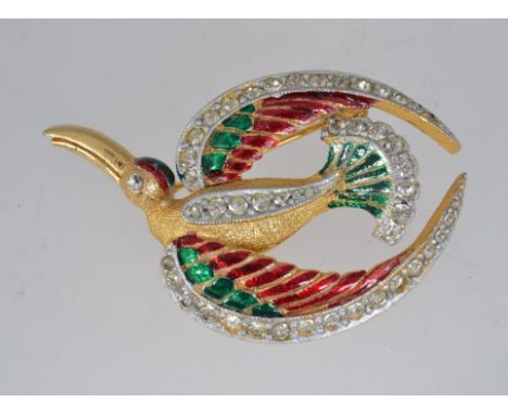 A vintage yellow metal enamelled  brooch pin  in the form of a bird of paradise with paste set wings, tail and eye with rolle