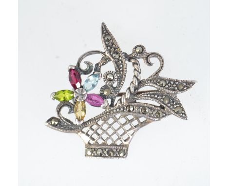 A vintage 925 silver brooch pin in the form of a posy basket with gemstone set flower and marcasite set foliates with roller 