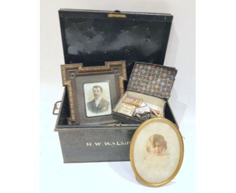 Antique Tin Trunk and Contents.This trunk contains a selection of miscellaneous items, including, pictures, bric a brac, butt