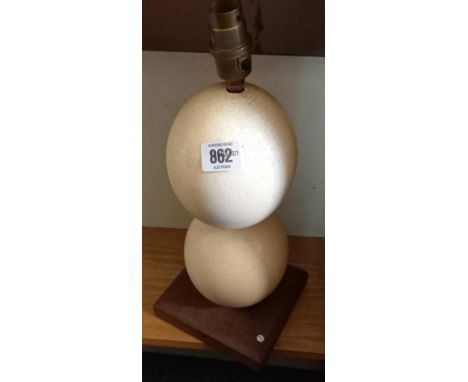 TABLE LAMP BASE FORMED OF 2 INTER JOINED OSTRICH EGGS ON WOODEN PLINTH (NO WIRES) A/F