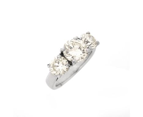 Vintage Approx. 3.24 Carat TW Round Brilliant Cut Diamond and Platinum Three Stone Ring. Set in the center with an approx. 1.