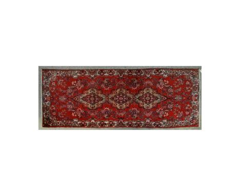Semi-Antique Persian Hamadan Rug. Label attached en verso. Floral patterns on red ground. Measures 119" x 43-1/2". Condition: