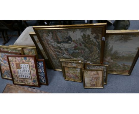 A large selection of framed embroideries including period scenes and a similar sampler type item. (12)