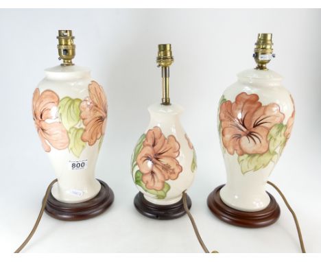 Three Moorcroft Hibiscus pattern Table Lamps - 2 x 26.5cm, 1 x 19.5cm excluding bases and brass light fittings. (3)