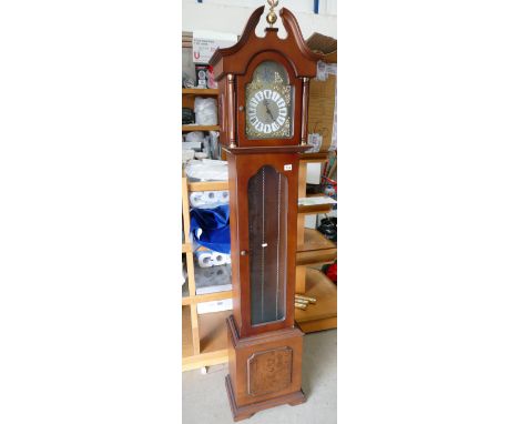A reproduction mahogany longcase clock, with a walnut panel.
