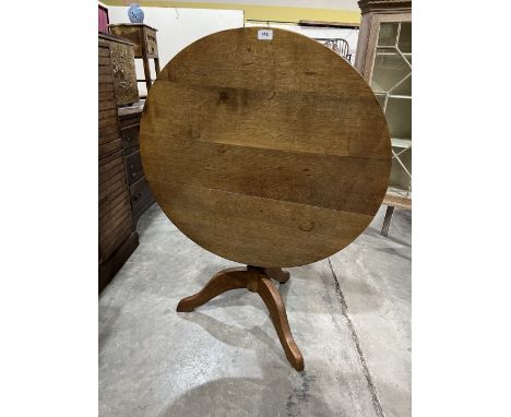 An oak snap-top tripod table. 33' diam