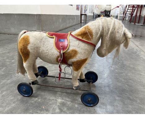 A Steiff push-along skewbald horse with voice box. Button in ear, 29' long x 23' high