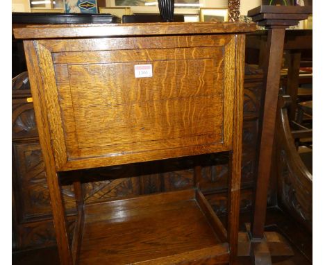 1930s oak occasional furniture to include; a hinge top work box, a standard lamp, and a freestanding ashtray (3)