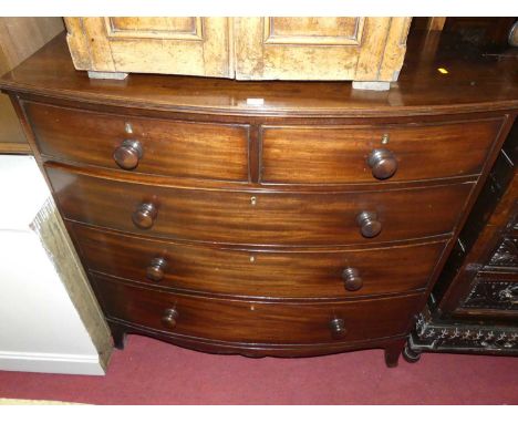 A Regency mahogany bowfront chest of two short over three long graduated drawers, with turned knob handles, raised on slightl