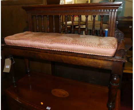 A Victorian oak twin window seat, the raised architectural style back with turned spindles to scroll arms on further turned a