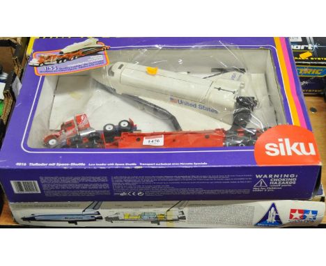 A Siku No. 4016 low loader with space shuttle, together with a Tamiya 1/100 scale space shuttle Orbiter plastic kit