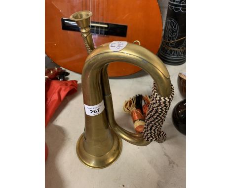 A VINTAGE BRASS MILITARY BUGLE WITH BRAIDED CORD AND TASSELS 