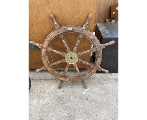 A VINTAGE WOODEN SHIPS WHEEL WITH BRASS CENTRE 