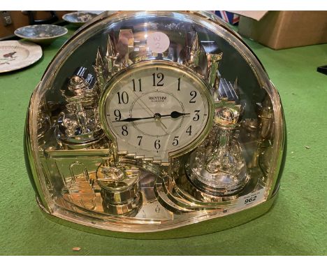 A RHYTHM QUARTZ HALF MOON MANTEL CLOCK 