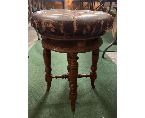 A VINTAGE ROUND LEATHER BUTTONED PIANO STOOL 