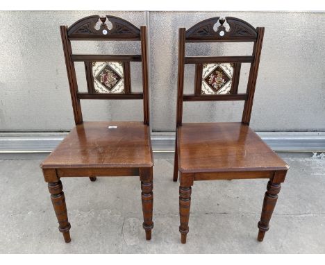 A PAIR OF VICTORIAN MAHOGANY HALL CHAIRS WITH INSET TILE BACKS 