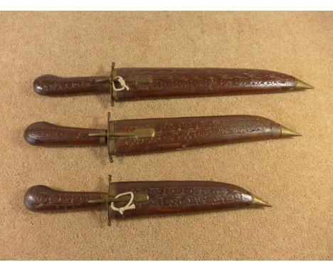 THREE INDIAN KNIVES WITH WOODEN GRIPS AND SCABBARD, SIZE OF BLADES 19CM TO 29CM 