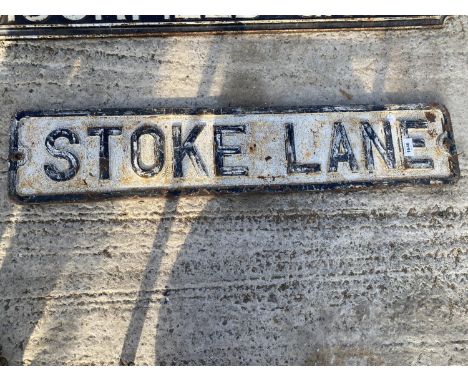 A VINTAGE CAST IRON 'STOKE LANE' ROAD SIGN 
