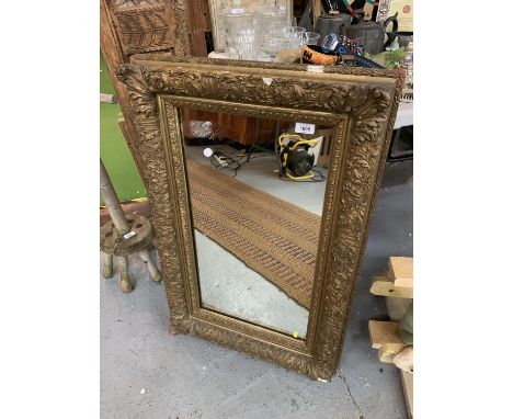 A DECORATIVE GILT FRAMED PORTRAIT ORIENTATED MIRROR (67X55CM) 