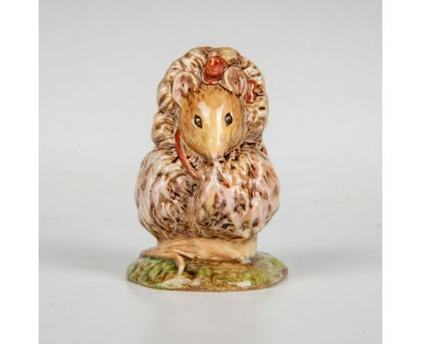 Depicts a small mouse wearing a large fur coat with brown and pink highlights. Beswick backstamp. This item has its original 