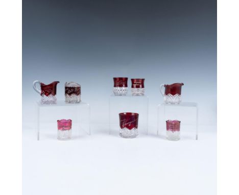 A captivating set of eight toothpick holders, pitchers, and a mug featuring a striking design with a vibrant red top body and