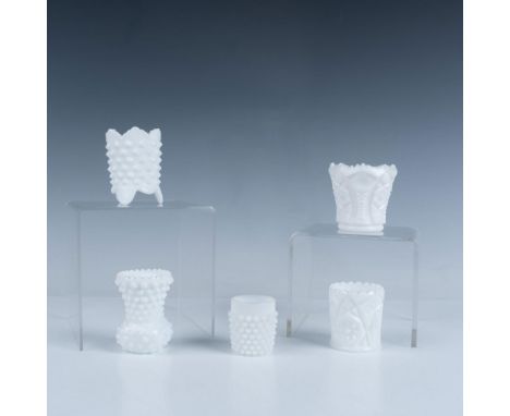 Beautiful milk glass toothpick holders in a variety of designs. Three have a hobnail pattern and the other two have bold sun 