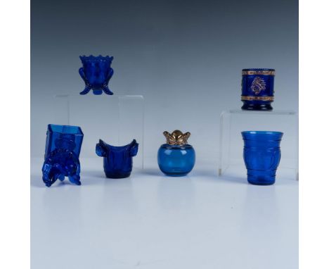 An eclectic lot of cobalt blue glass toothpick holders. Two have gilt detailing, one is footed, one has a simple circular des