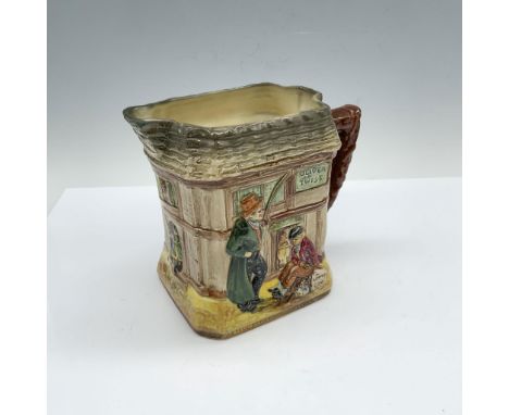 Glossy porcelain pitcher with three scenes from the Oliver Twist novel by Charles Dickens with descriptions at the base. Roya