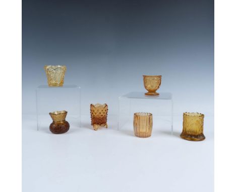 This lovely set features six amber toothpick holders, a hobnail footed holder, a chalice adorned with low relief hearts, a tr