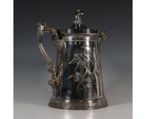 Imposing Victorian style silverplate insulated pitcher with a Cupid holding a goblet set on the top of the lid. The body is i